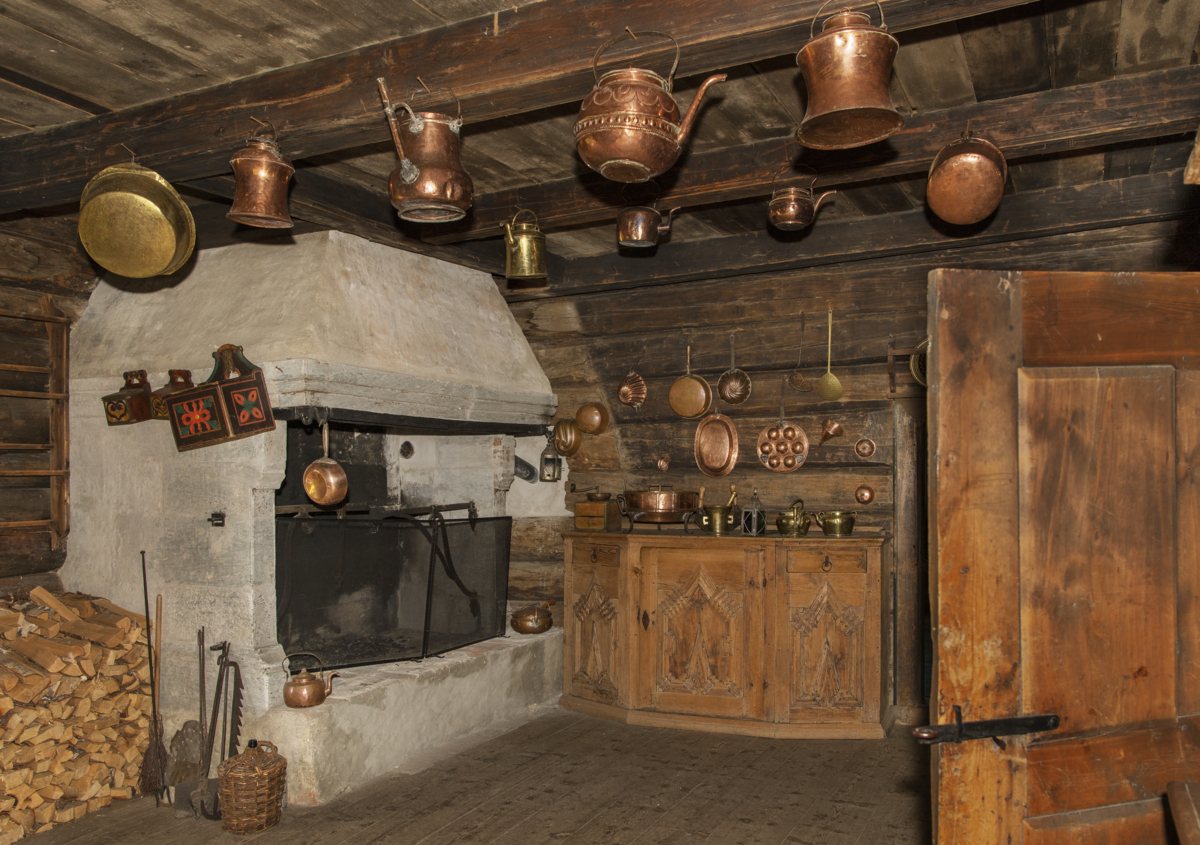 The kitchen with a soapstone fireplace and copper pots. Photo: Tone Iren Eggen T&oslash;mte/Maihaugen.

