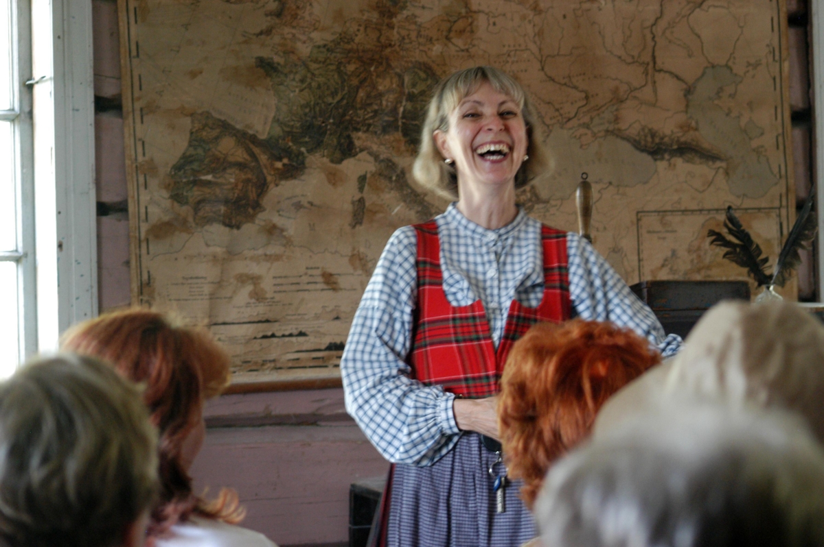 Happy teacher in the School House. Photo: Cecilie Owren.

