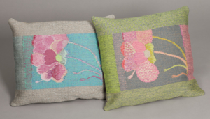 Pillows in tapestry with flowers.